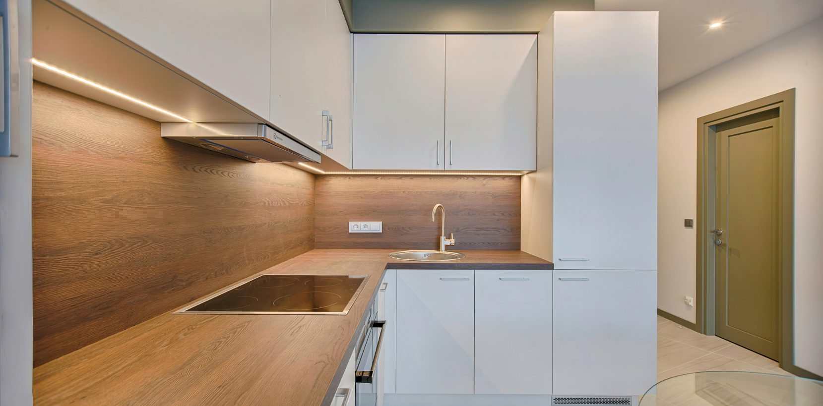 Modern vinyl wrap kitchen with sleek cabinets installed by the best interior wrapping services in Dubai